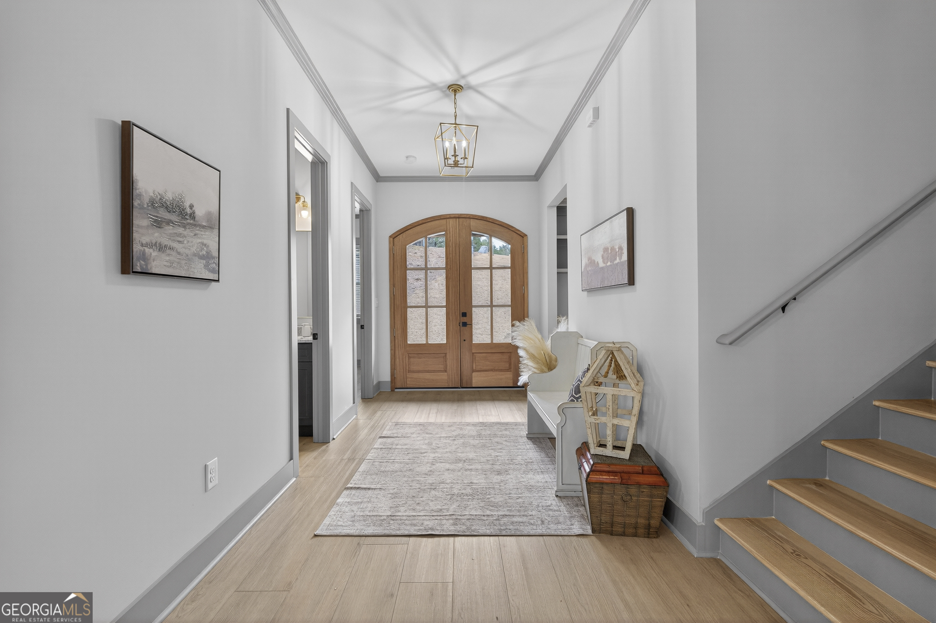 303 Tumbling Shoals Court Gray, GA 31032 - Photo 11 of 86 a view of a hallway with entryway wooden floor and front door