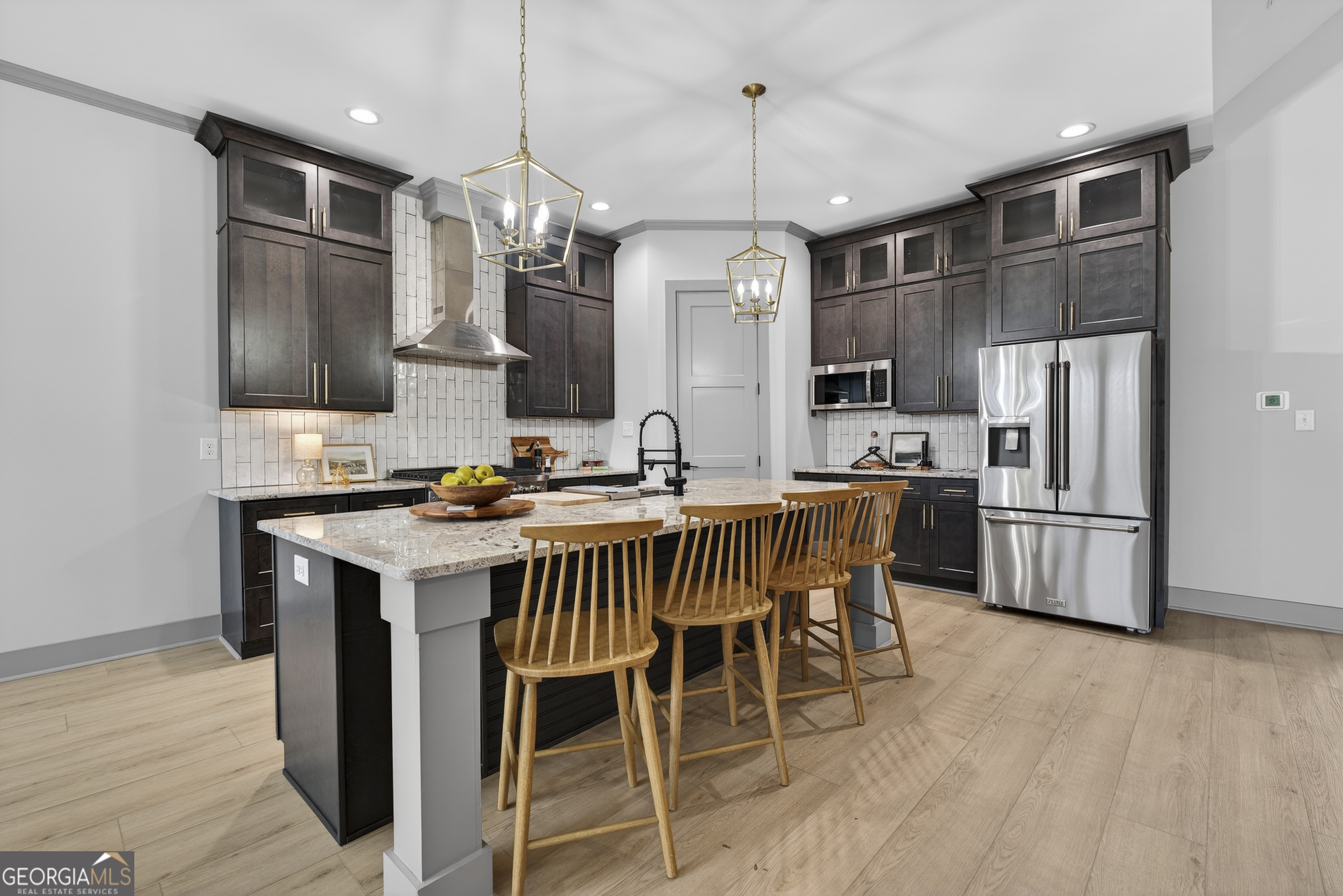 303 Tumbling Shoals Court Gray, GA 31032 - Photo 20 of 86 a kitchen with stainless steel appliances a dining table chairs stove refrigerator and microwave