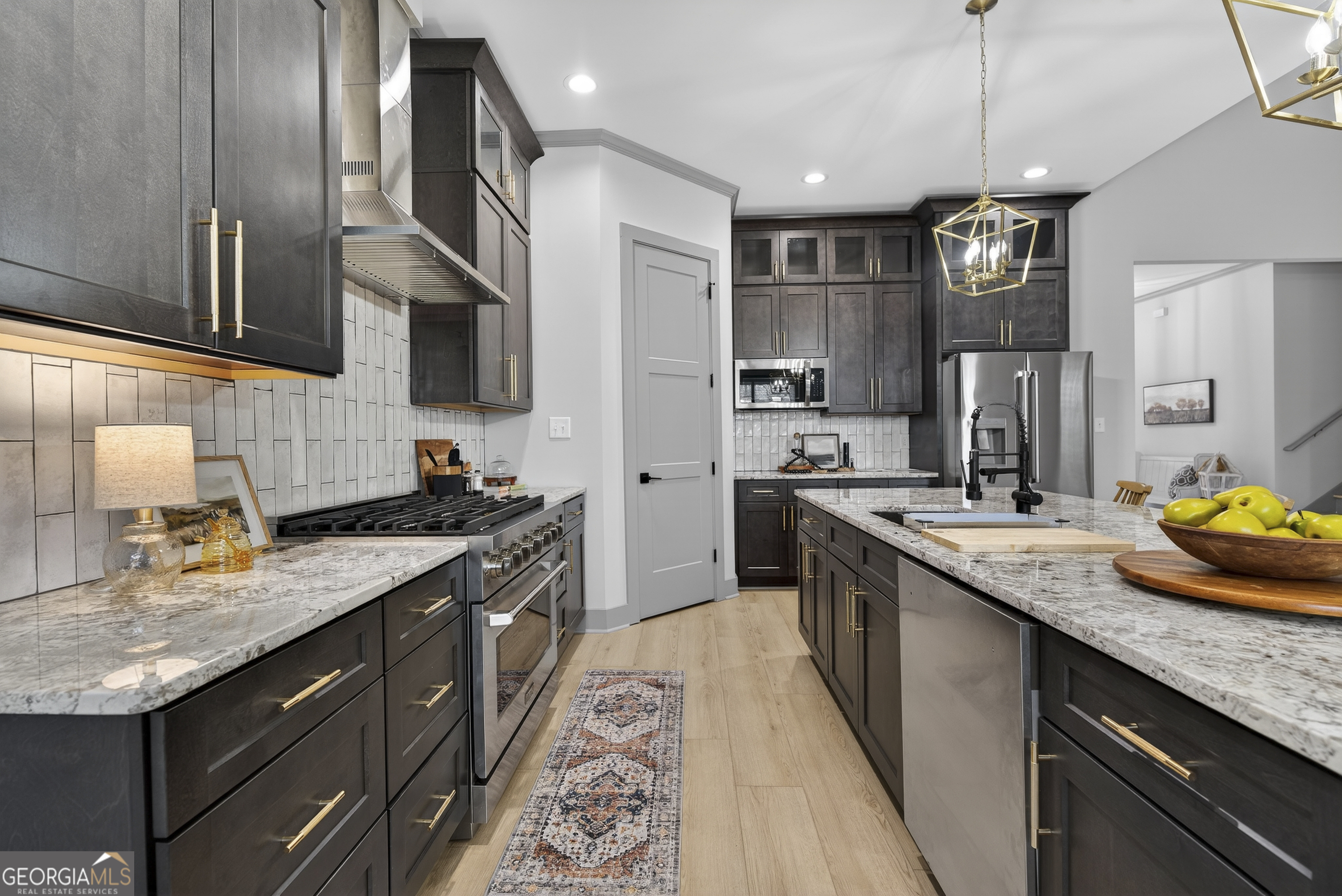 303 Tumbling Shoals Court Gray, GA 31032 - Photo 21 of 86 a kitchen with stainless steel appliances granite countertop a sink a stove and a wooden floors