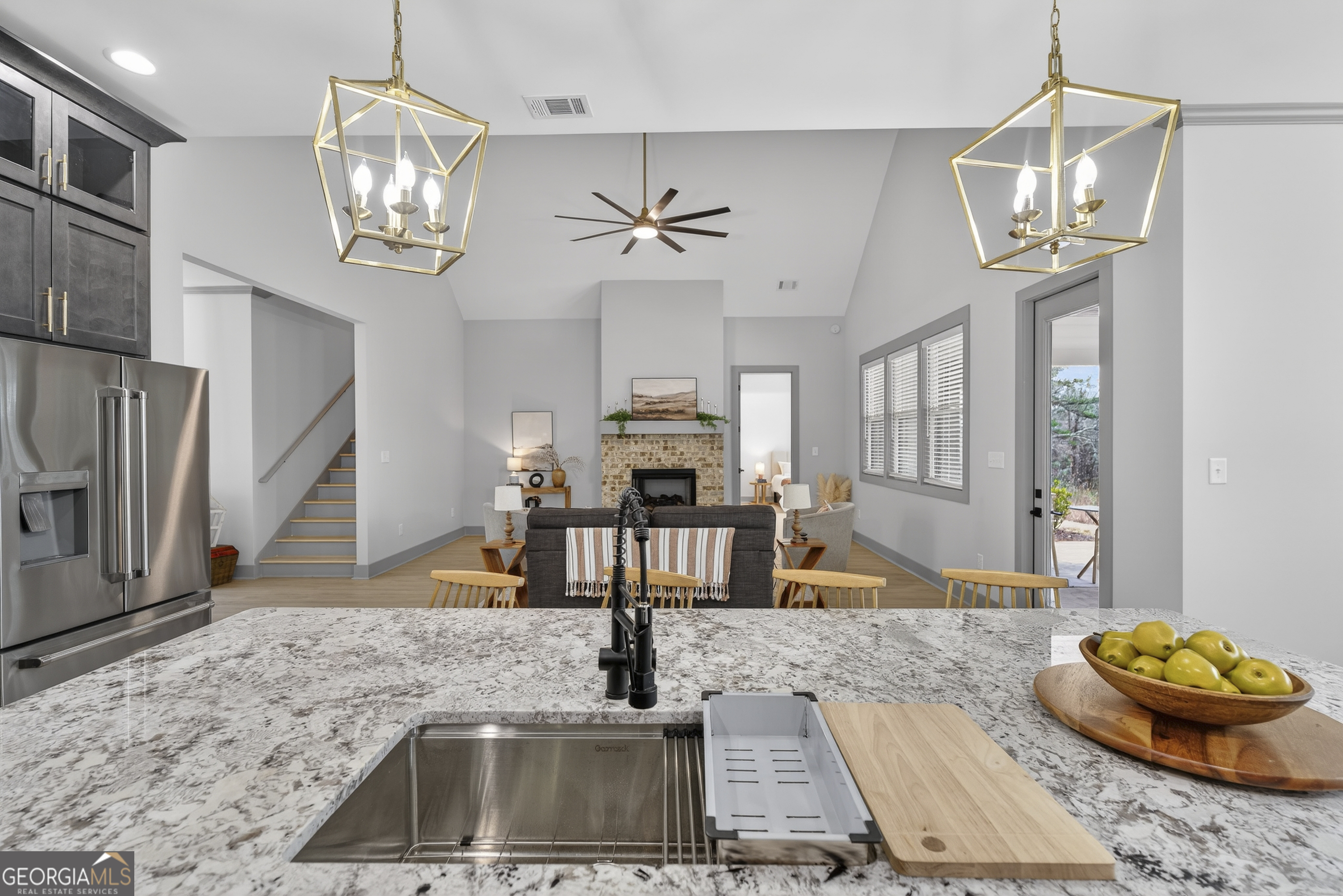 303 Tumbling Shoals Court Gray, GA 31032 - Photo 24 of 86 a living room with fireplace furniture and a chandelier