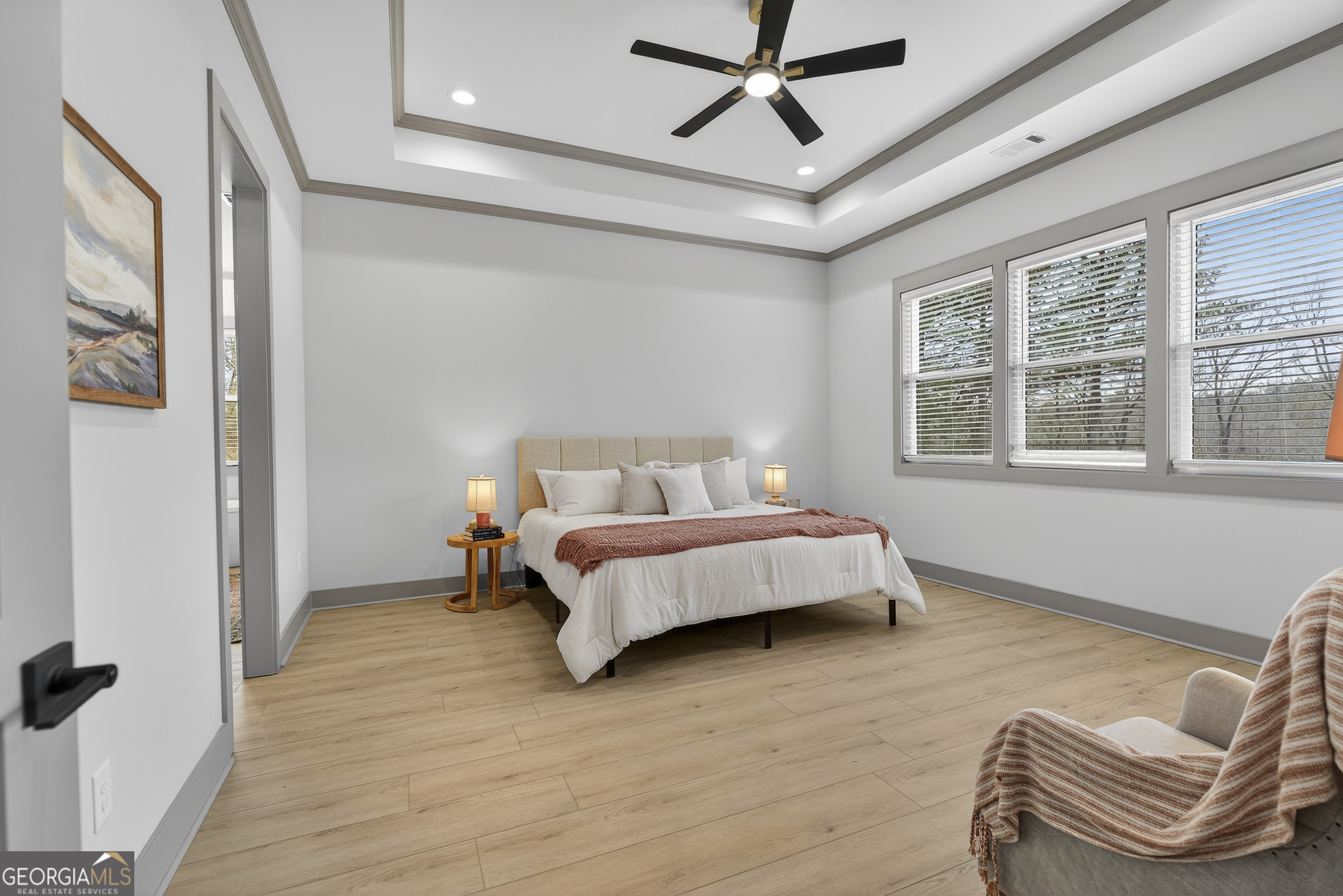 303 Tumbling Shoals Court Gray, GA 31032 - Photo 34 of 86 a spacious bedroom with a bed and a couch