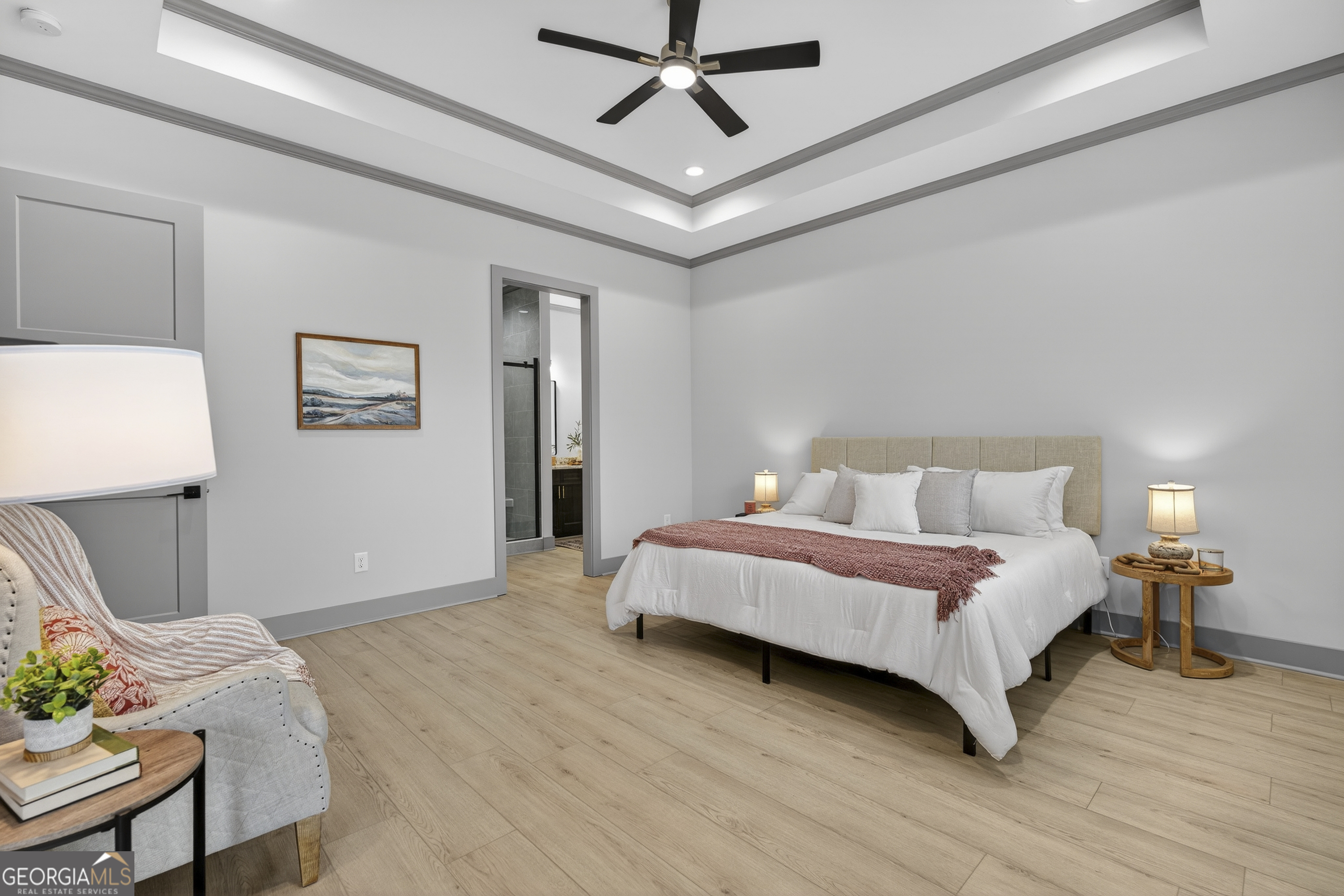 303 Tumbling Shoals Court Gray, GA 31032 - Photo 36 of 86 a spacious bedroom with a bed and a table