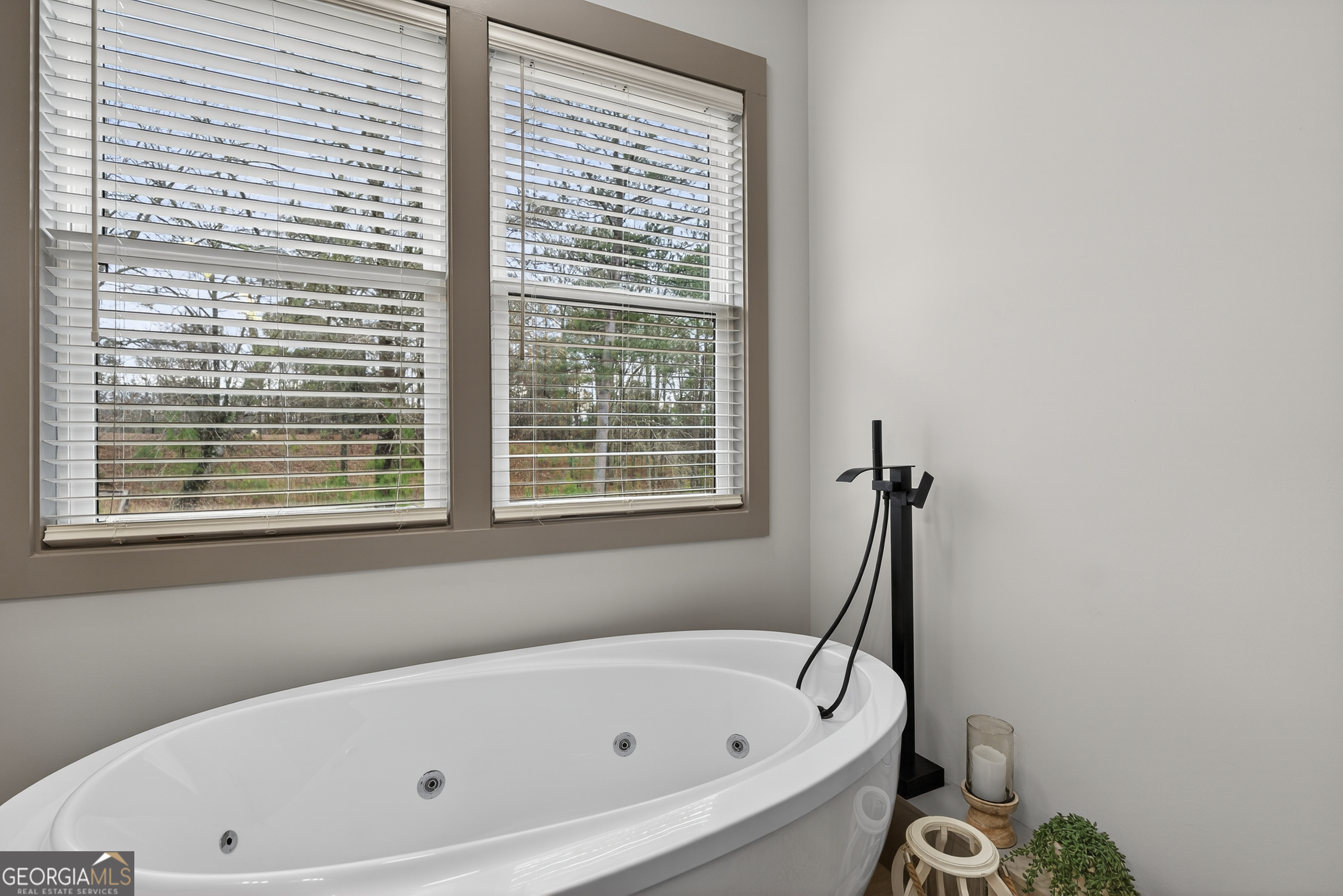 303 Tumbling Shoals Court Gray, GA 31032 - Photo 40 of 86 a bathroom with a bathtub and a window