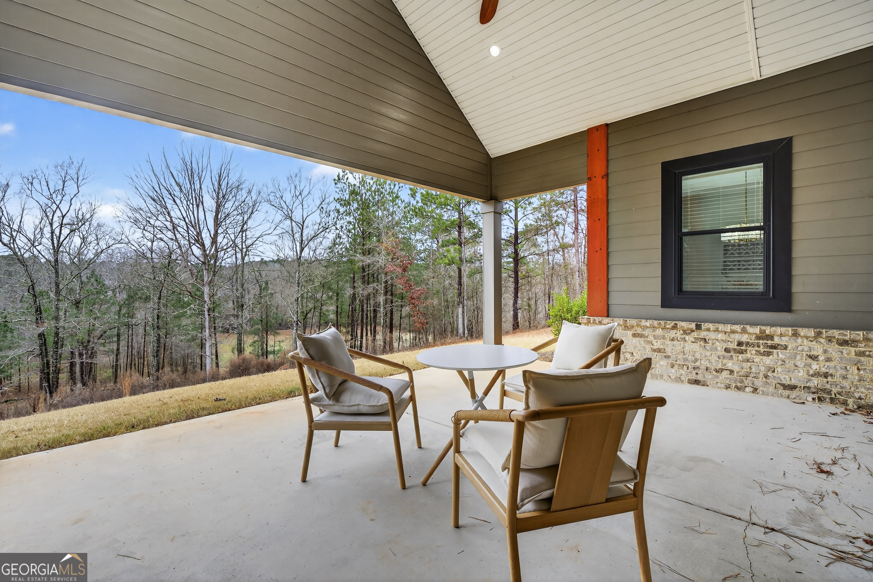 303 Tumbling Shoals Court Gray, GA 31032 - Photo 50 of 86 a view of an outdoor sitting area with furniture and wooden floor