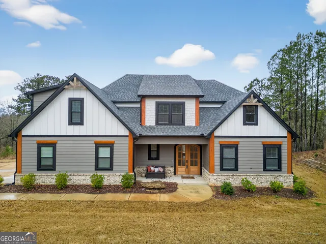 a bathroom with a granite countertop sink a toilet and a mirror
