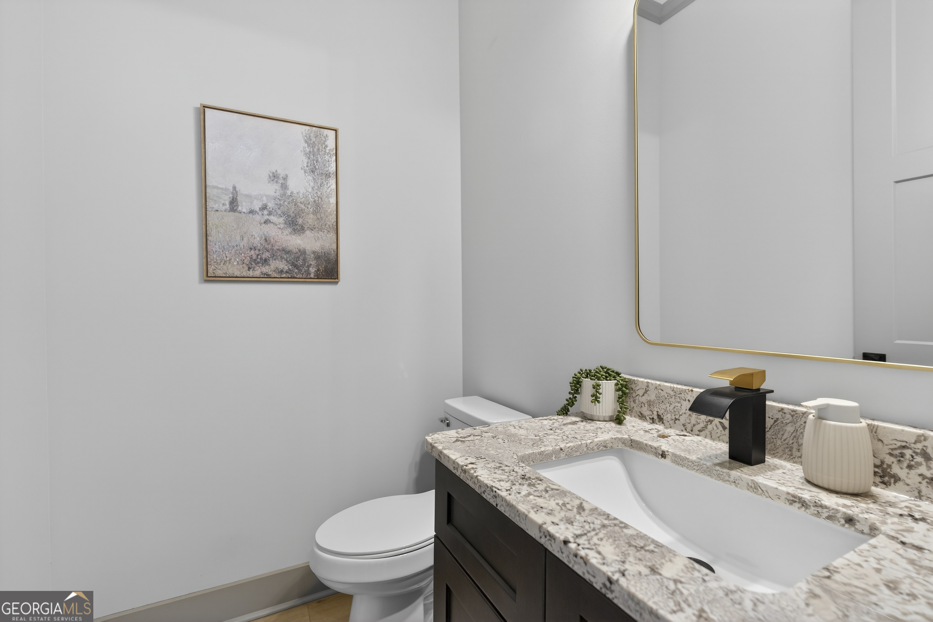303 Tumbling Shoals Court Gray, GA 31032 - Photo 57 of 86 a bathroom with a granite countertop sink and a toilet