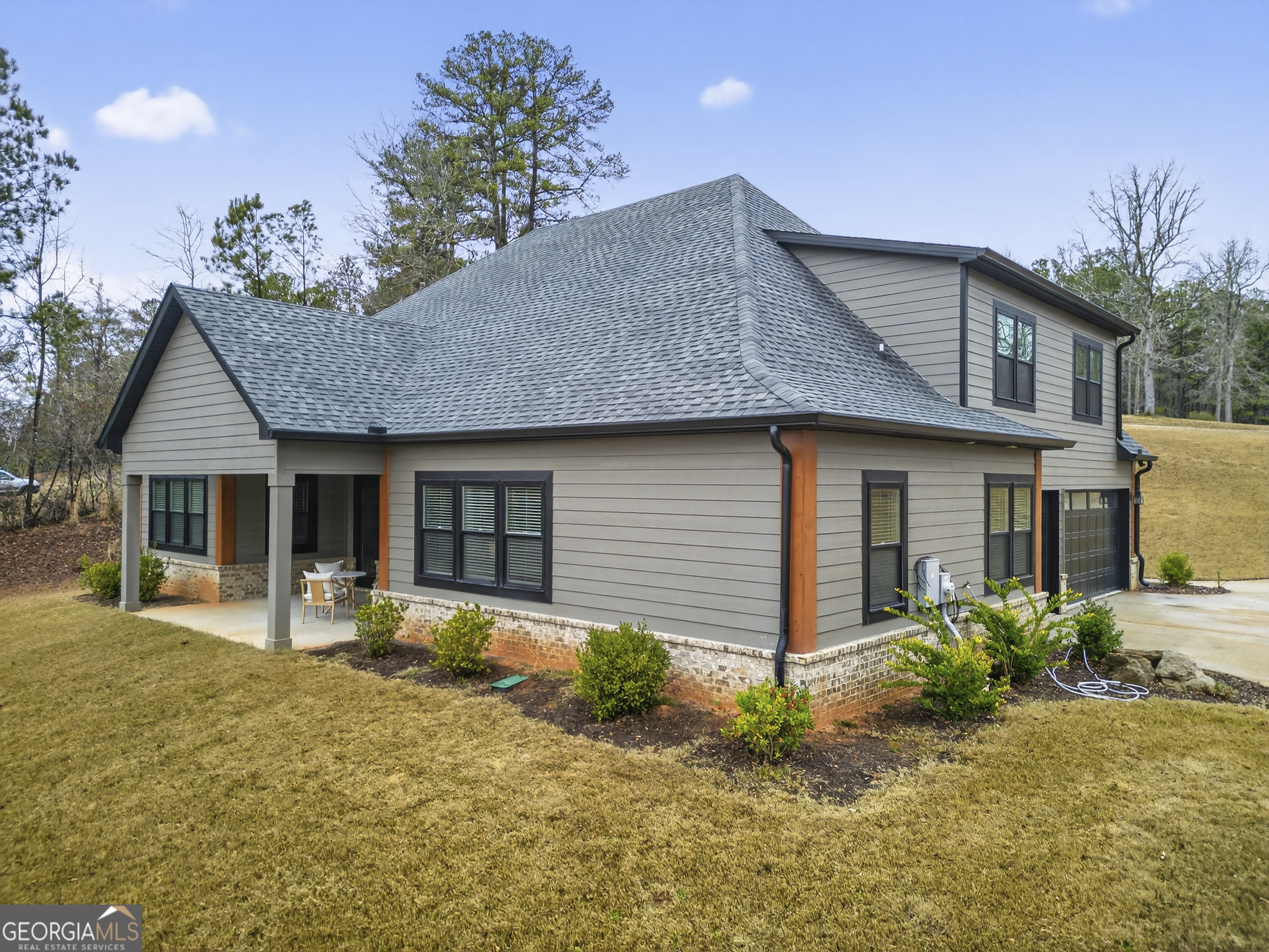 303 Tumbling Shoals Court Gray, GA 31032 - Photo 70 of 86 a front view of a house with a yard and potted plants