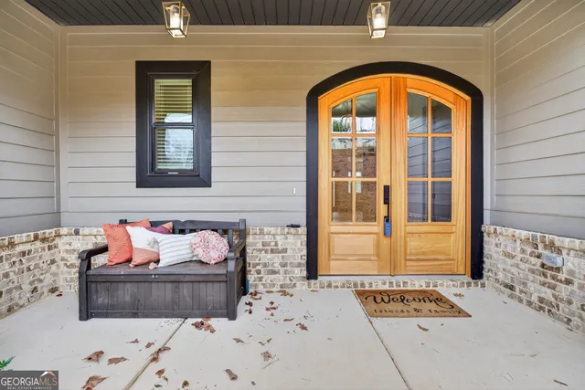a bathroom with a granite countertop toilet sink and mirror