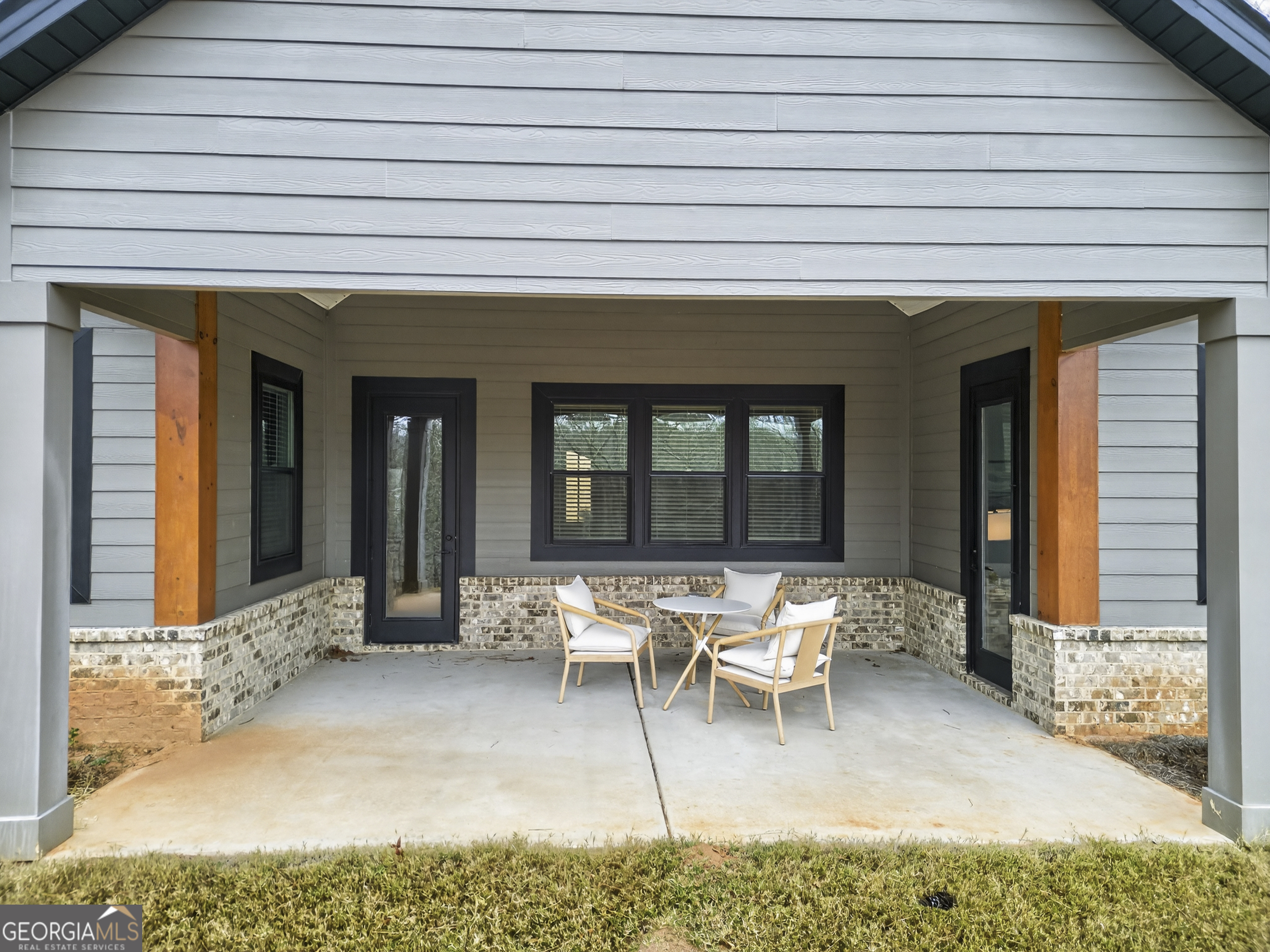 303 Tumbling Shoals Court Gray, GA 31032 - Photo 73 of 86 a view of a patio with table and chairs and potted plants