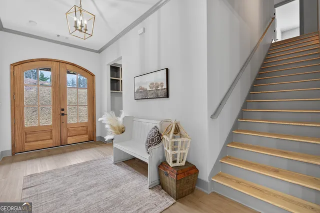 an empty room with ceiling fan and windows