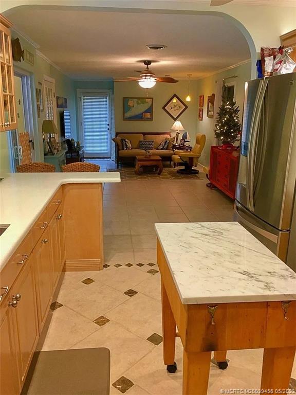 15 Miramar Road Stuart, FL 34996 - Photo 12 of 41 a kitchen with stainless steel appliances kitchen island granite countertop a refrigerator and stove