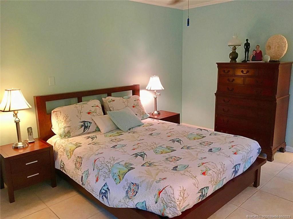 15 Miramar Road Stuart, FL 34996 - Photo 16 of 41 a bedroom with a bed and wooden floor