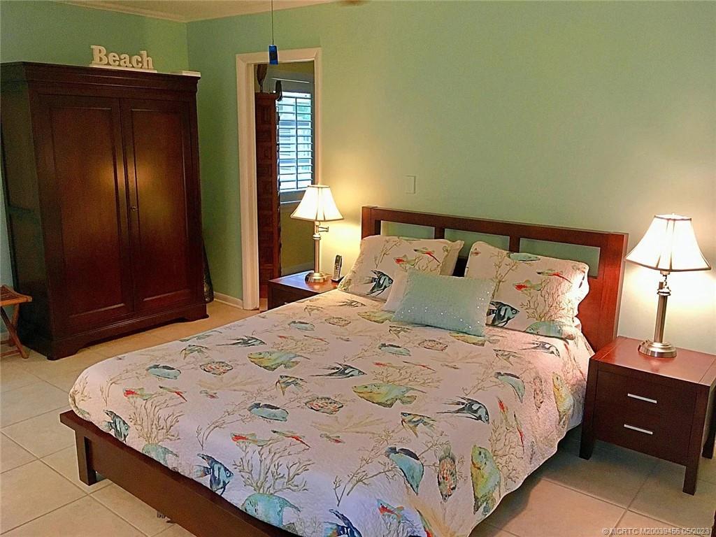 15 Miramar Road Stuart, FL 34996 - Photo 17 of 41 a bedroom with a bed and a lamp