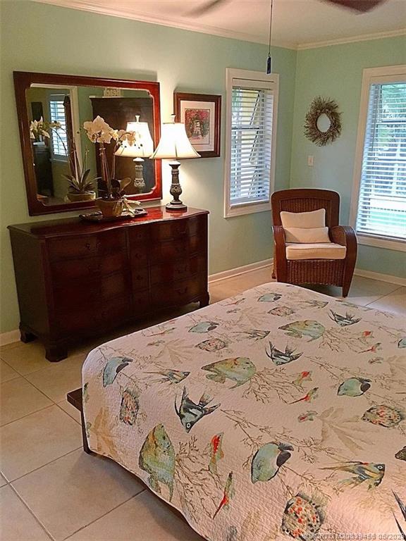 15 Miramar Road Stuart, FL 34996 - Photo 18 of 41 a bedroom with a bed and wooden floor