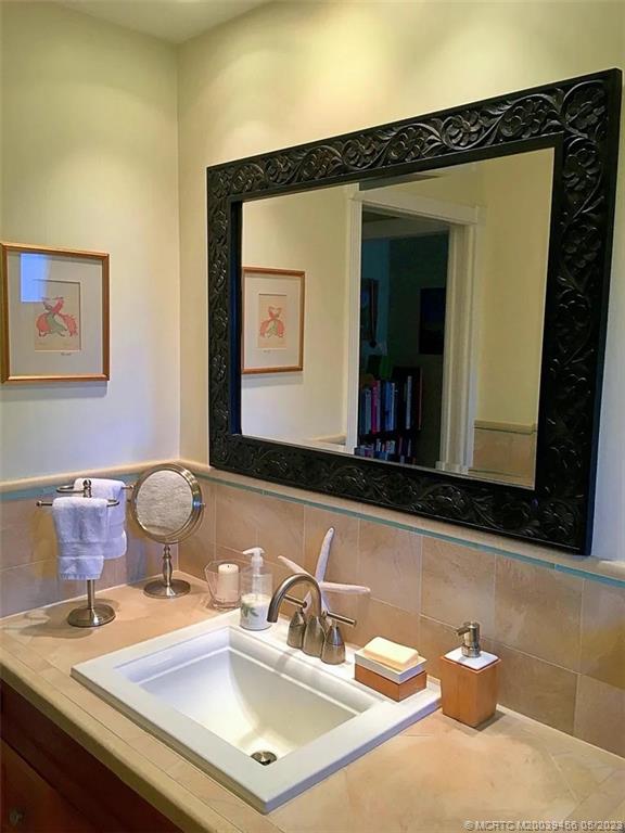 15 Miramar Road Stuart, FL 34996 - Photo 20 of 41 a bathroom with a sink and a mirror