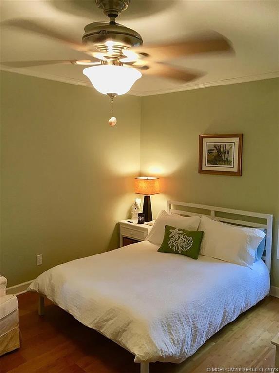 15 Miramar Road Stuart, FL 34996 - Photo 26 of 41 a bedroom with a bed and chandelier