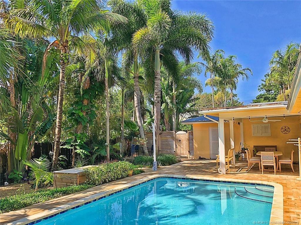 15 Miramar Road Stuart, FL 34996 - Photo 3 of 41 a view of a backyard with couches under an umbrella