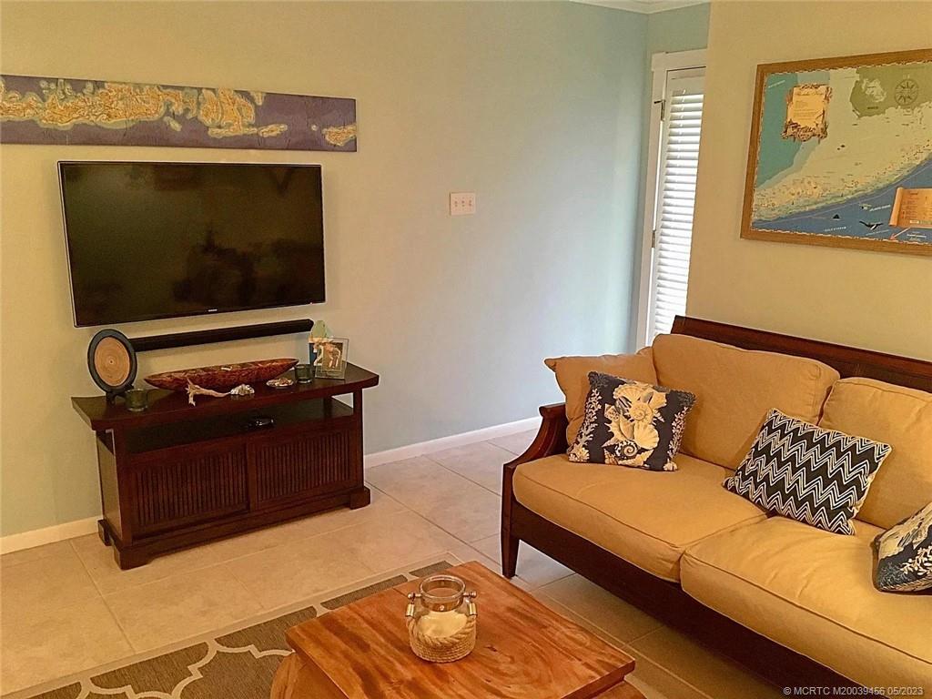 15 Miramar Road Stuart, FL 34996 - Photo 7 of 41 a living room with a couch and a flat screen tv