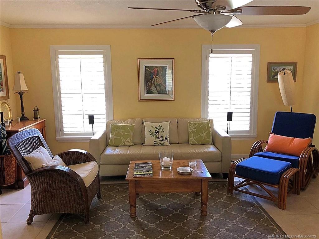 15 Miramar Road Stuart, FL 34996 - Photo 8 of 41 a living room with furniture a flat screen tv and a window