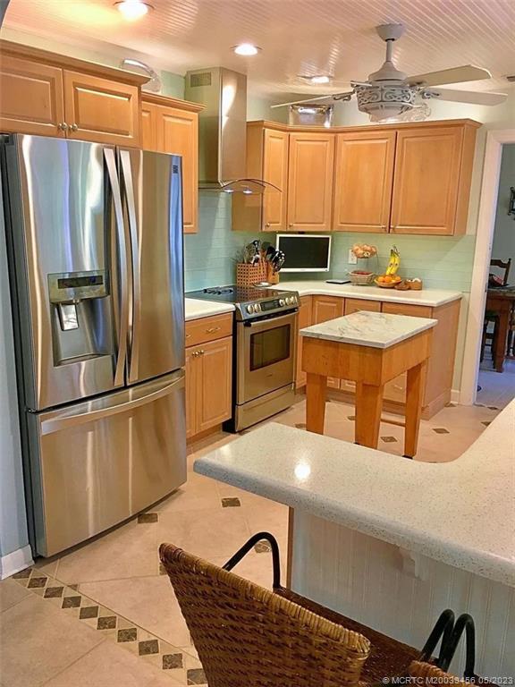 15 Miramar Road Stuart, FL 34996 - Photo 9 of 41 a kitchen with stainless steel appliances granite countertop a refrigerator a stove and a sink