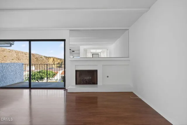 a view of a room with wooden floor and staircase