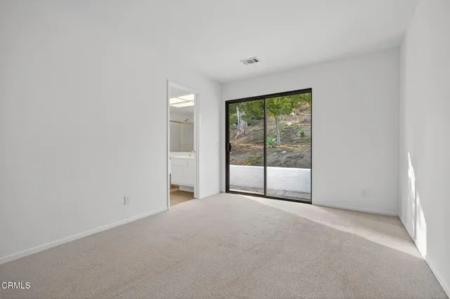 a bathroom with a granite countertop sink a toilet and a mirror