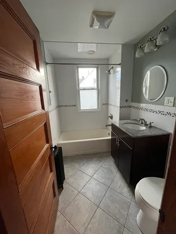 a bathroom with a sink vanity mirror and toilet
