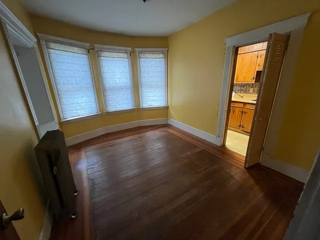 a view of front door with wooden floor