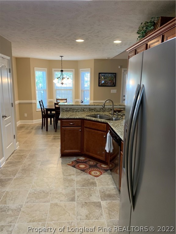 27 Germantown Road Cameron, NC 28326 - Photo 31 of 39 a kitchen with stainless steel appliances granite countertop a sink a stove a refrigerator a dining table and chairs