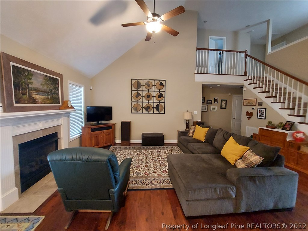 27 Germantown Road Cameron, NC 28326 - Photo 8 of 39 a living room with furniture a fireplace and a flat screen tv