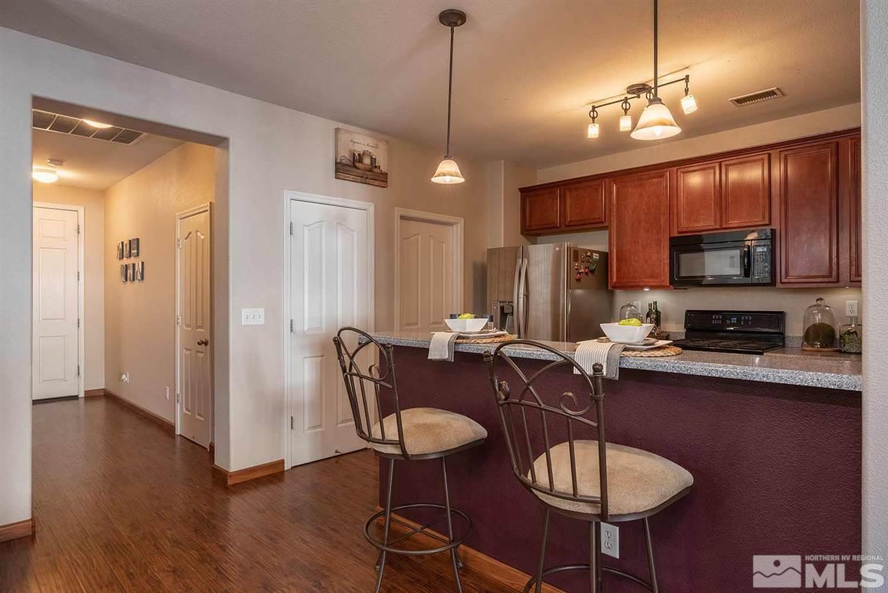 395 Terracina Way Reno, NV 89521 - Photo 5 of 25 a view of a dining room with furniture wooden floor and chandelier