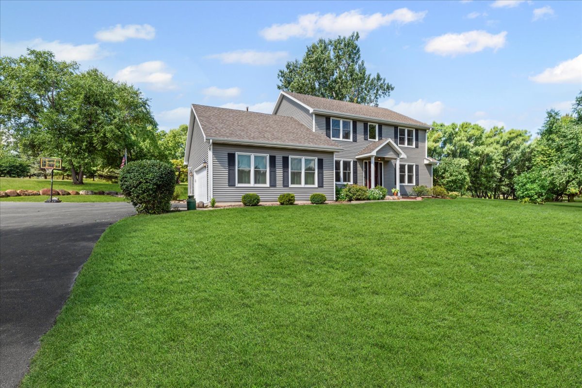 11111 Huron Drive Spring Grove, IL 60081 - Photo 4 of 5 a front view of a house with a garden and trees