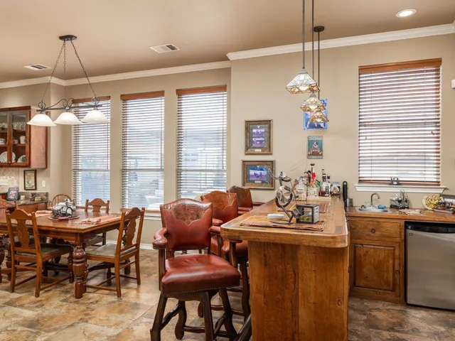 a room with granite countertop lots of counter top space and furniture