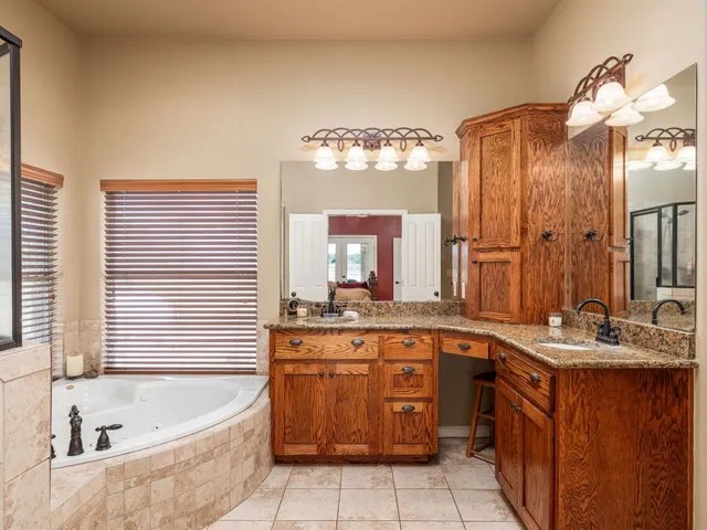 a bathroom with a tub sink and mirror