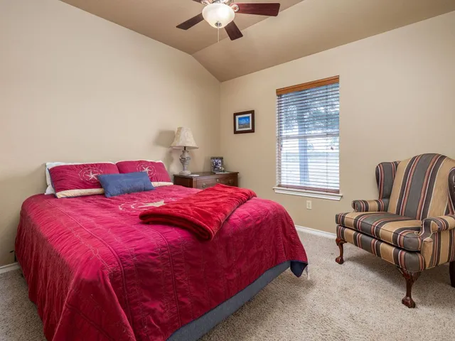 a spacious bedroom with a bed and a couch