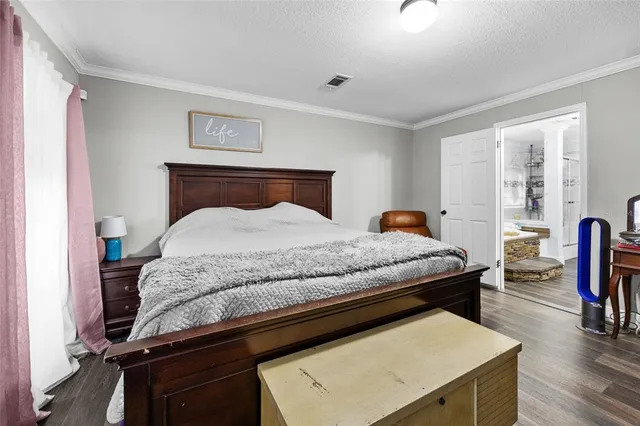 a spacious bathroom with double vanity and a large mirror
