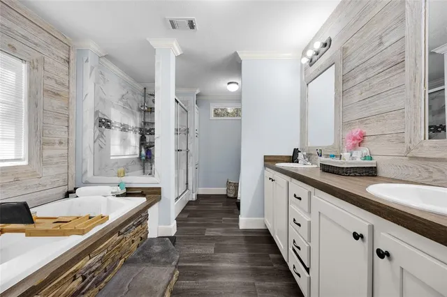 a spacious bathroom with double vanity and a mirror