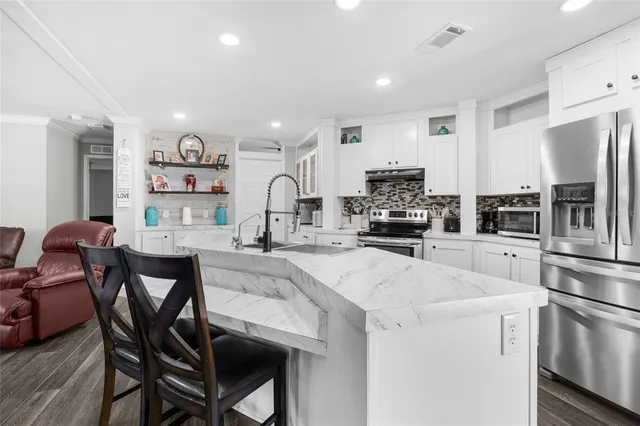 a living room with furniture and a ceiling fan