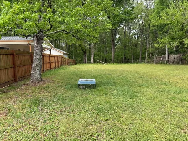 a backyard of a house with table and chairs