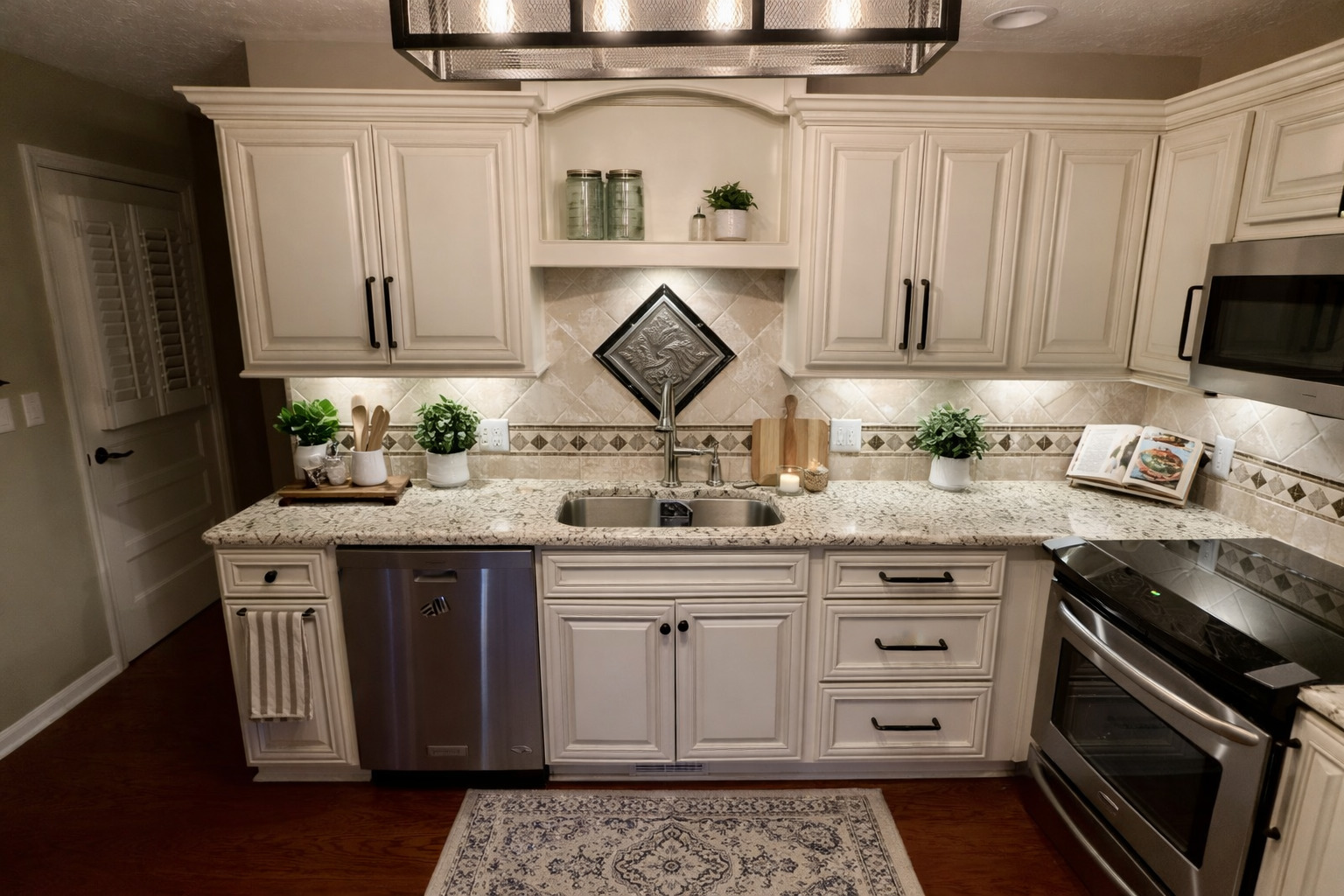 209 Baker Street Metropolis, IL 62960 - Photo 12 of 43 a kitchen with stainless steel appliances granite countertop a sink stove and cabinets