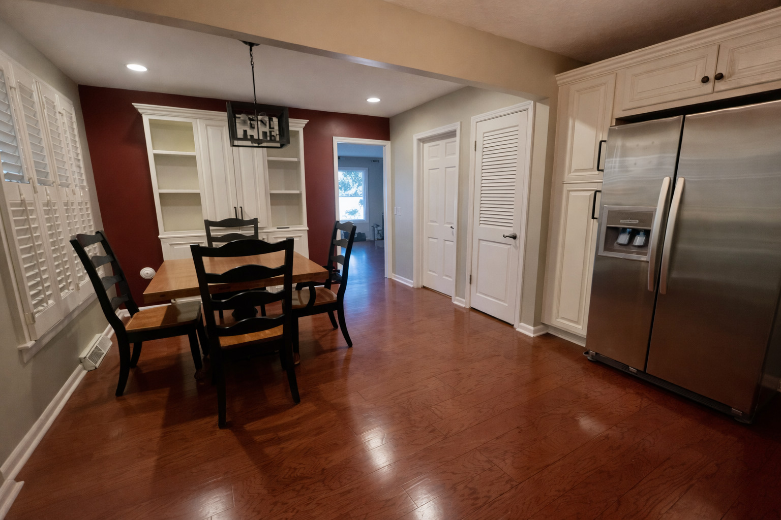209 Baker Street Metropolis, IL 62960 - Photo 14 of 43 a kitchen with stainless steel appliances wooden floor dining table and chairs