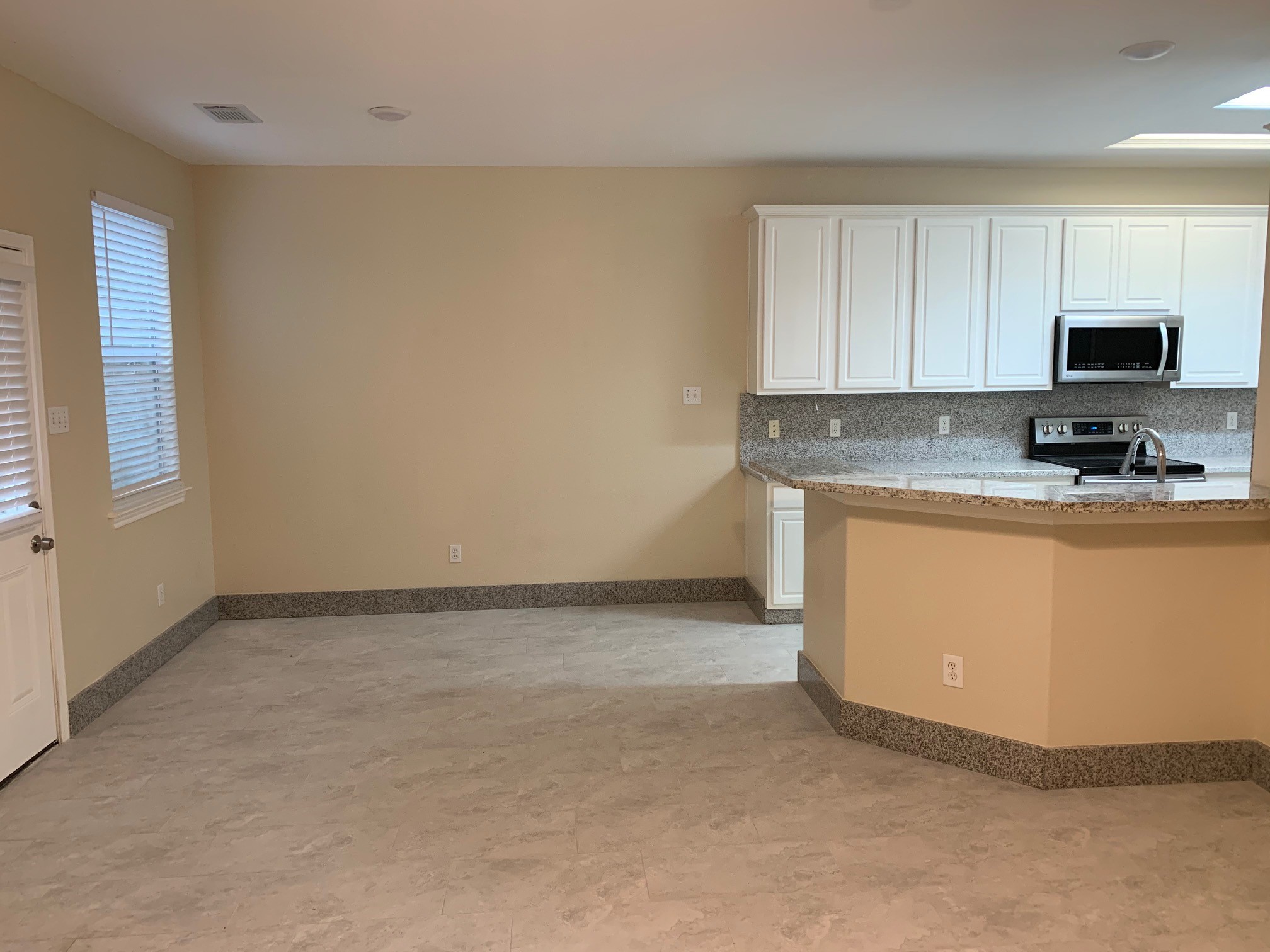 42 Blue Creek Place Spring, TX 77382 - Photo 5 of 18 a view of a kitchen with microwave and cabinets