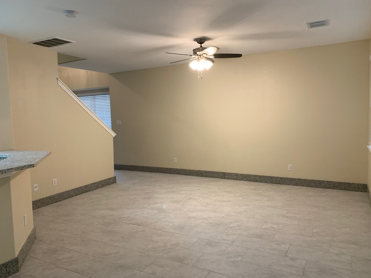 42 Blue Creek Place Spring, TX 77382 - Photo 7 of 18 a view of an empty room with chandelier fan and a window