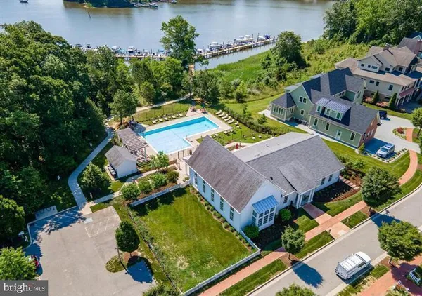 an aerial view of residential house with outdoor space and lake view