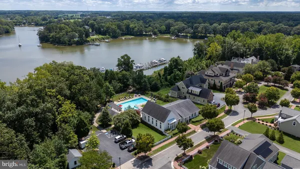 an aerial view of a house with a yard lake view and mountain view
