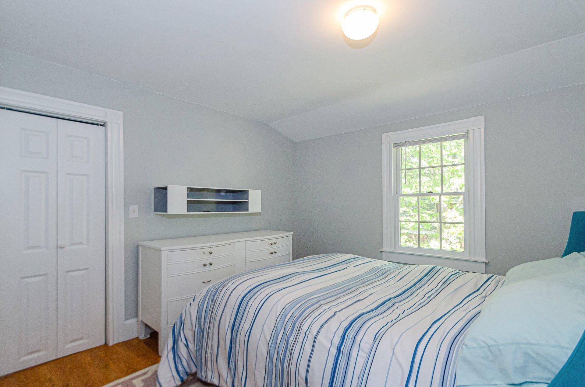 1089 Main Street Cotuit, MA 02635 - Photo 31 of 41 a bedroom with a bed and a window