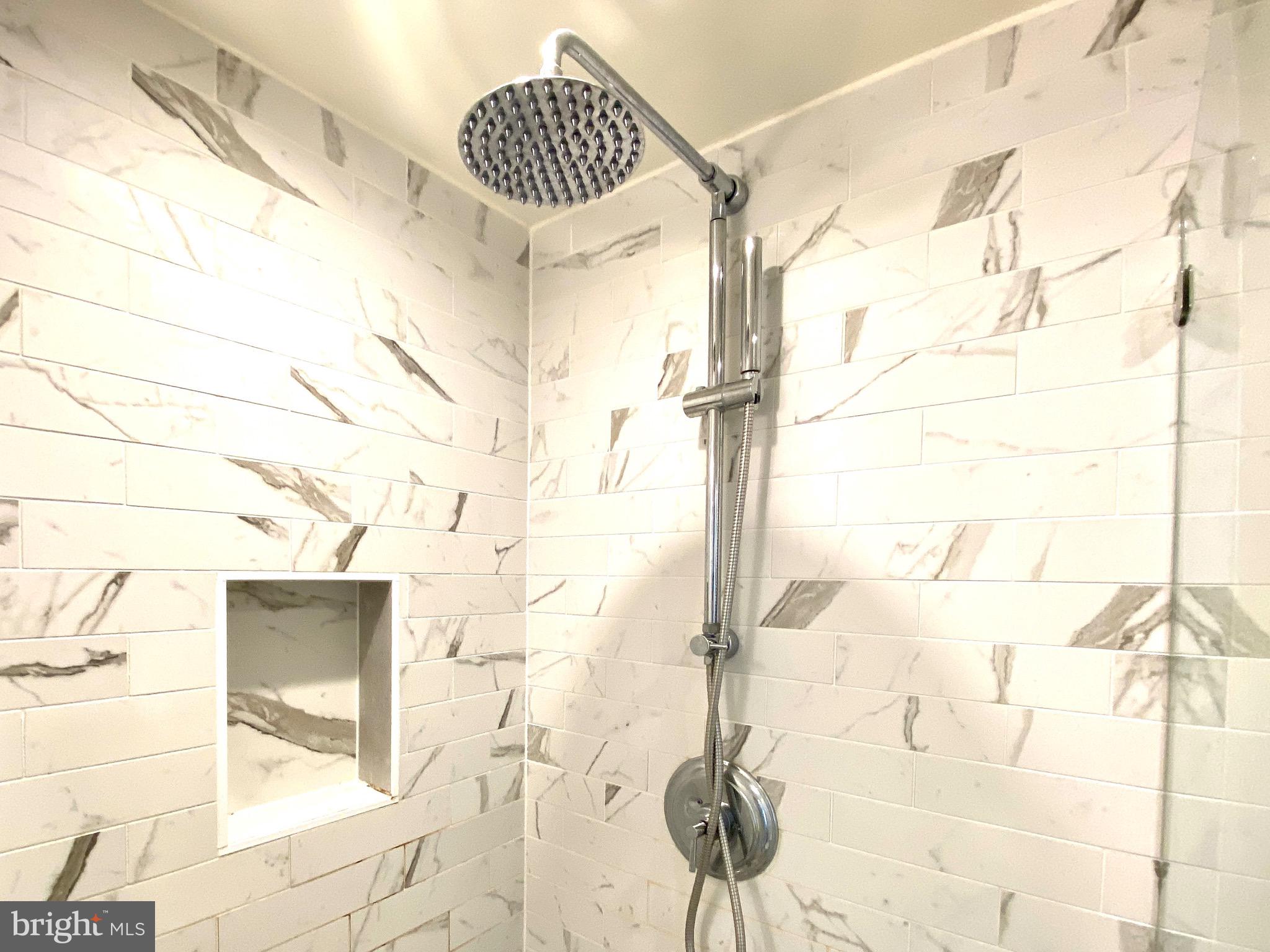 3120 R Street Northwest, Unit 107 Washington, DC 20007 - Photo 16 of 33 Classic subway tile and upgraded shower system