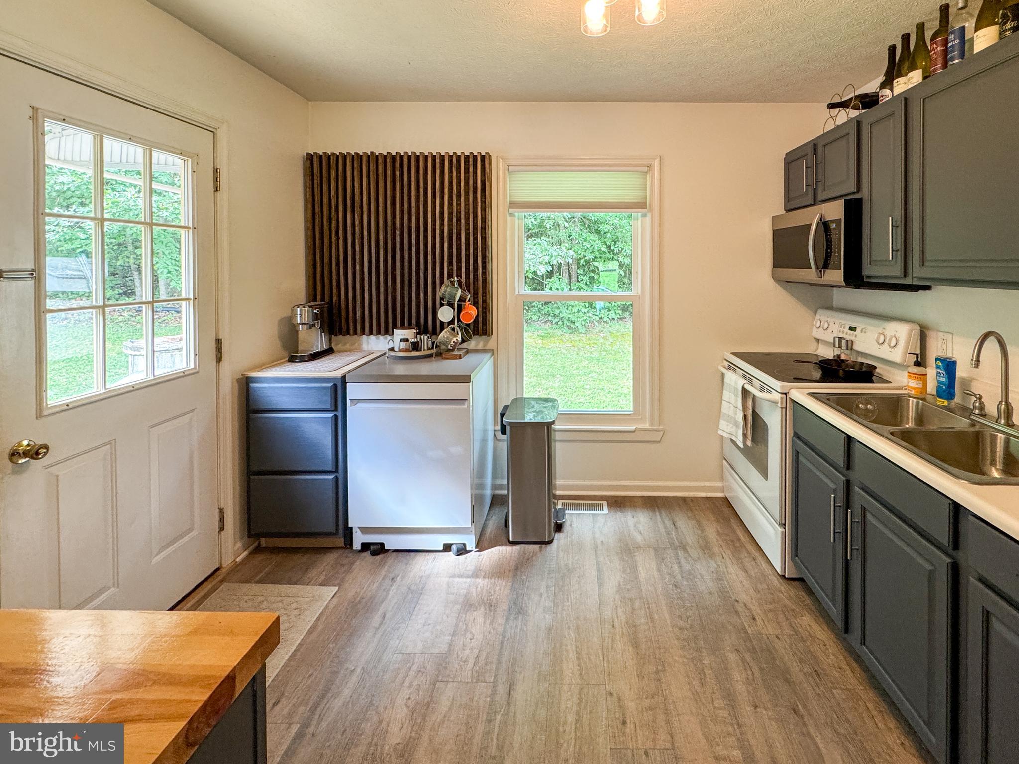 3843 Buckner Road Mineral, VA 23117 - Photo 7 of 26 a kitchen with stainless steel appliances granite countertop a sink stove and refrigerator