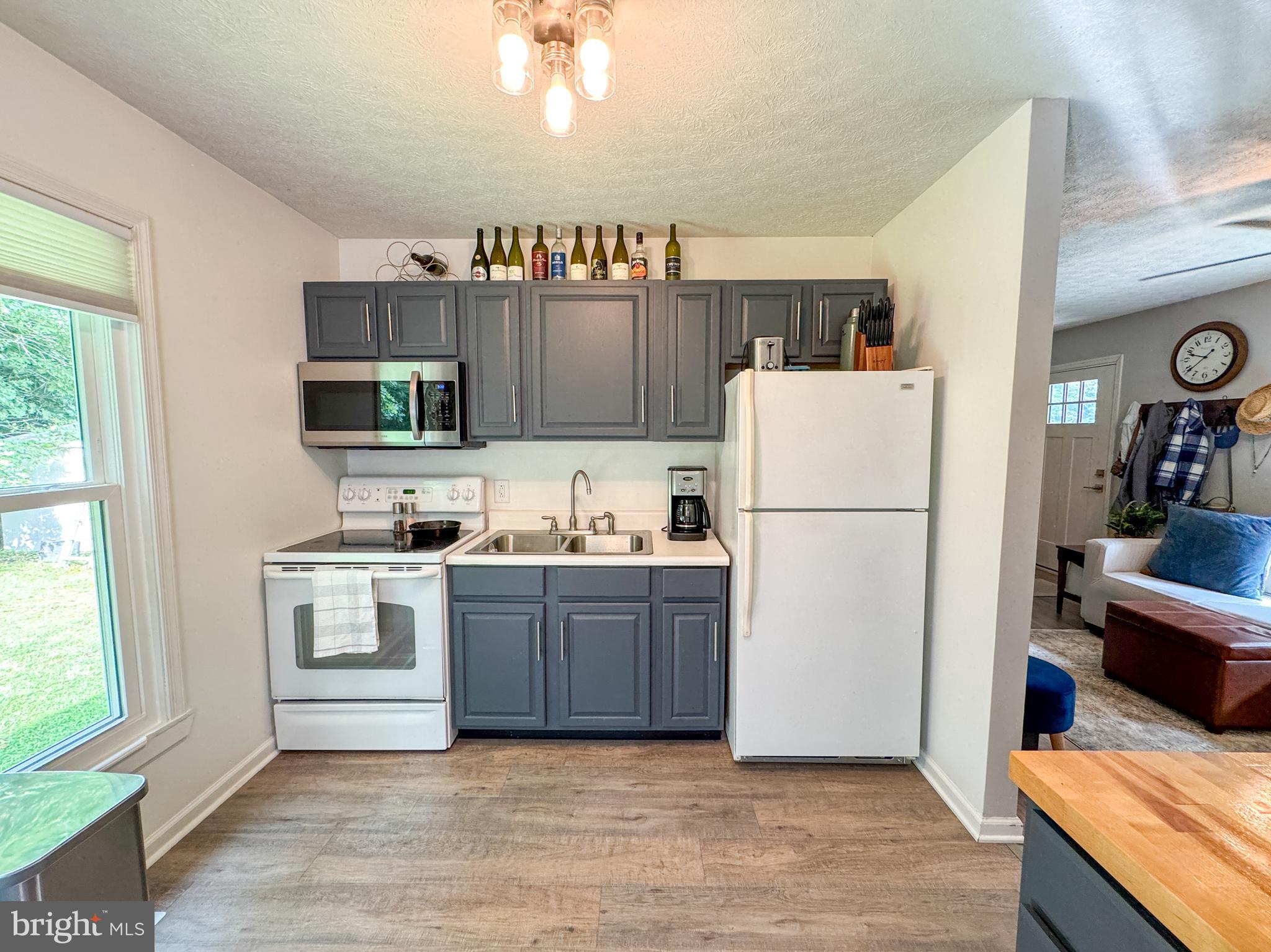 3843 Buckner Road Mineral, VA 23117 - Photo 8 of 26 a kitchen with a refrigerator a stove top oven a sink and a window
