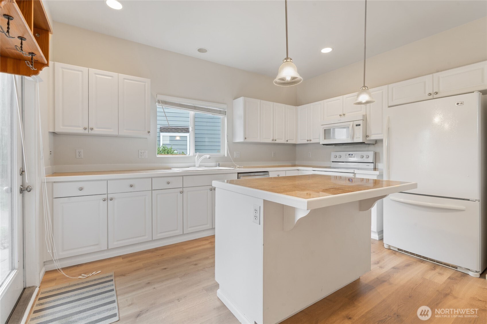 16919 165th Place Southeast Renton, WA 98058 - Photo 11 of 29 a kitchen with white cabinets and white appliances